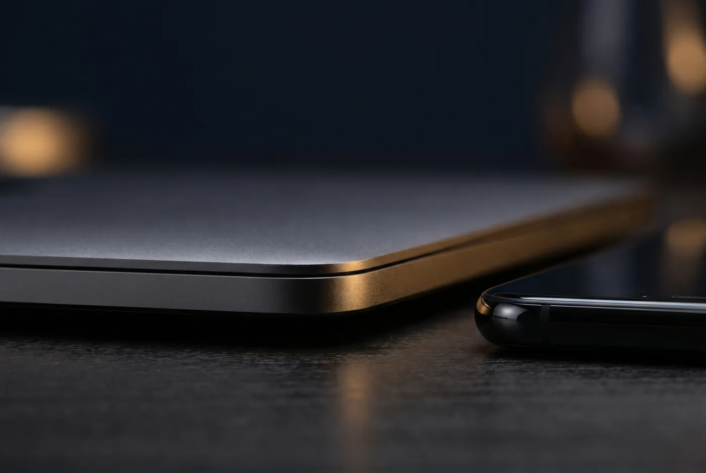 Premium hardware on a dark desk, warm gold rim light.